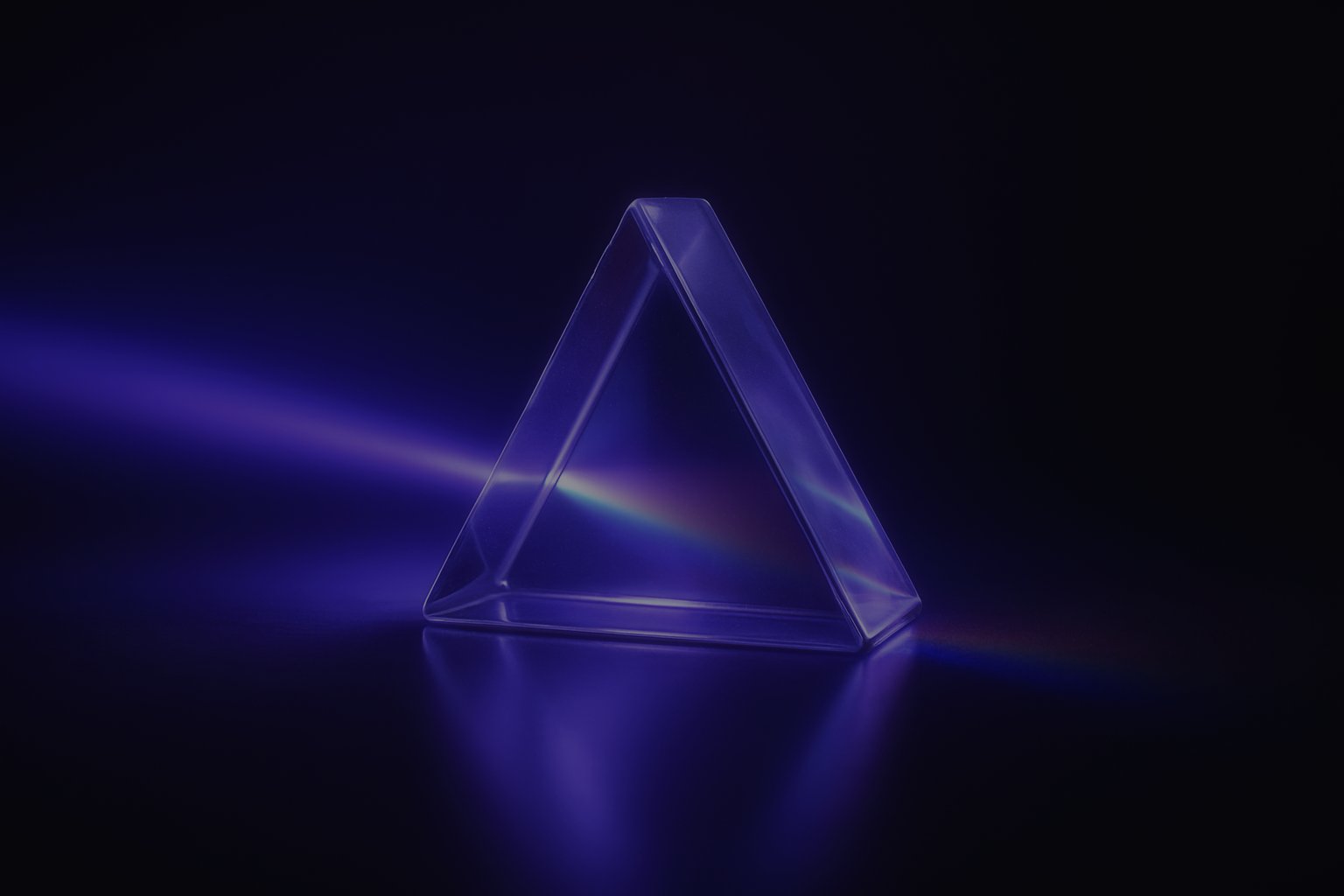 Triangular glass prism splitting a beam, representing techniques to optimize images for SEO